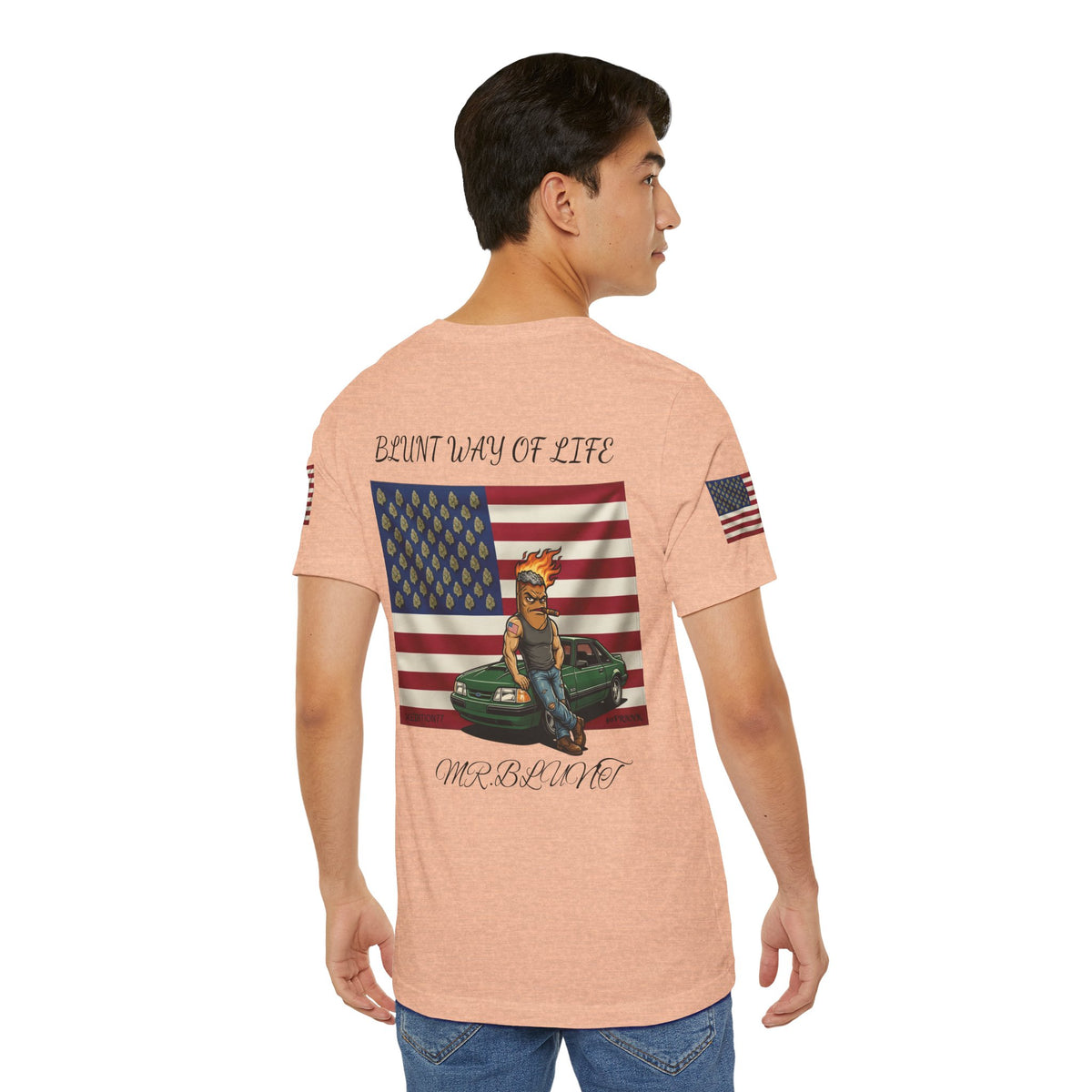 Model wearing peach Mr. Blunt tee, back view showing flag, character and green car graphic.
