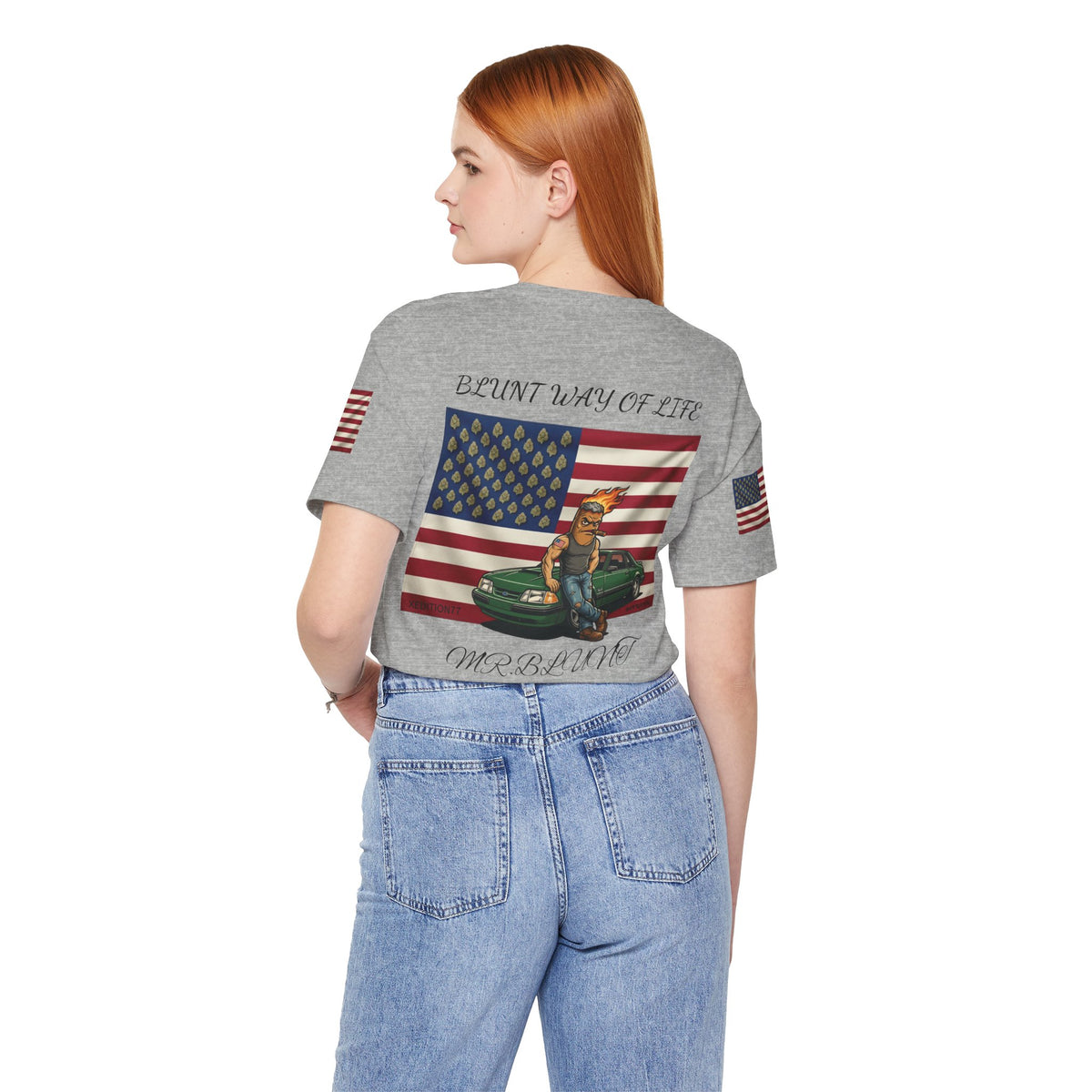 Model wearing heather gray Mr. Blunt tee with jeans, back view showing flag, character and green car artwork.