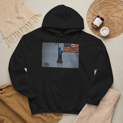 Statue of Liberty flag hoodie featuring misty skyline and American flag design on a cozy black sweatshirt.