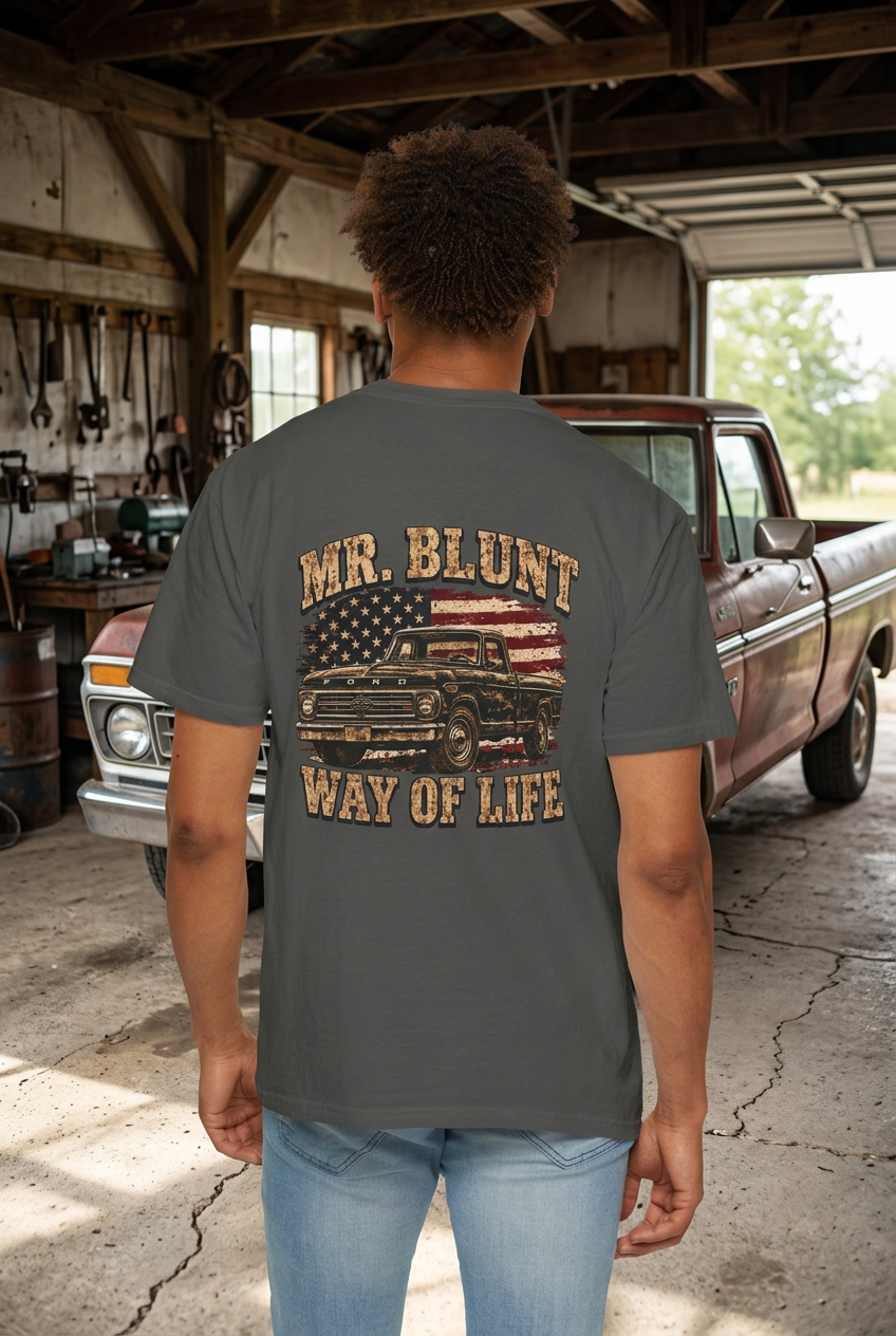 Mr. Blunt truck-shirt model with a rural garage background
